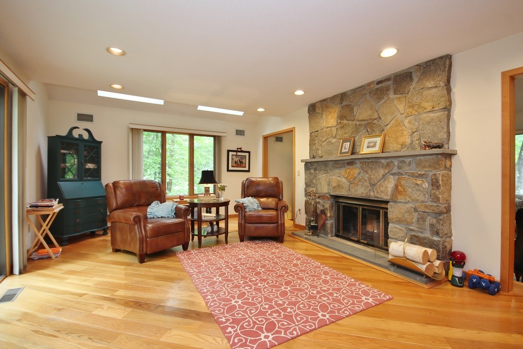 Family Room w. two sky lights and stone fireplace w. mantle