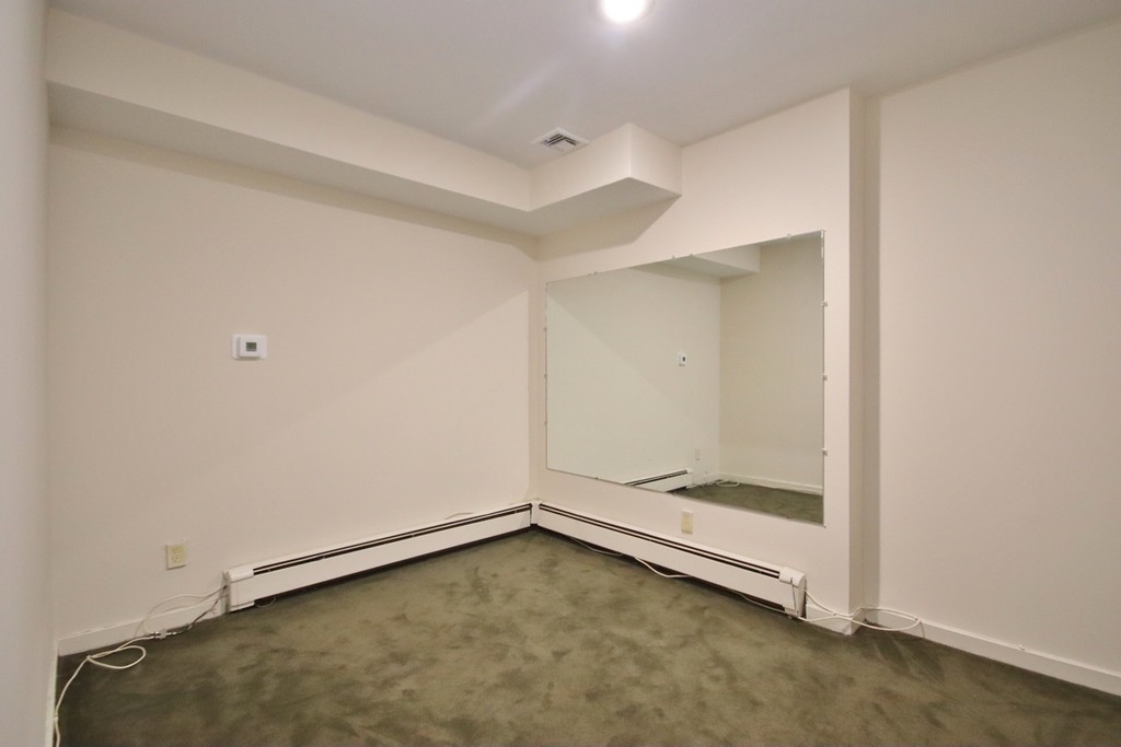 Room with wall to wall carpet and recessed lighting