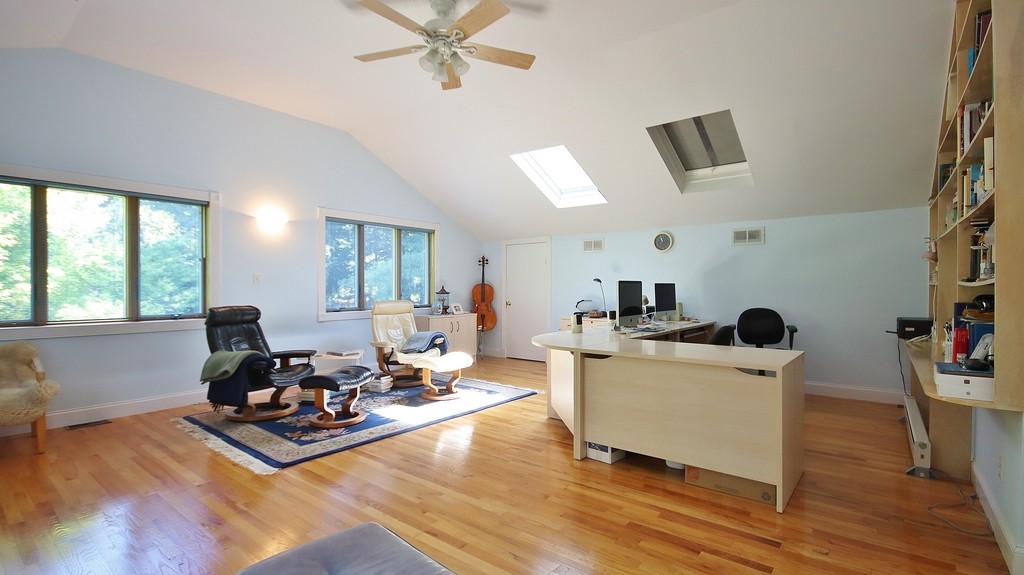 Office off Primary Bedroom has hardwood floors and ceiling fan with light